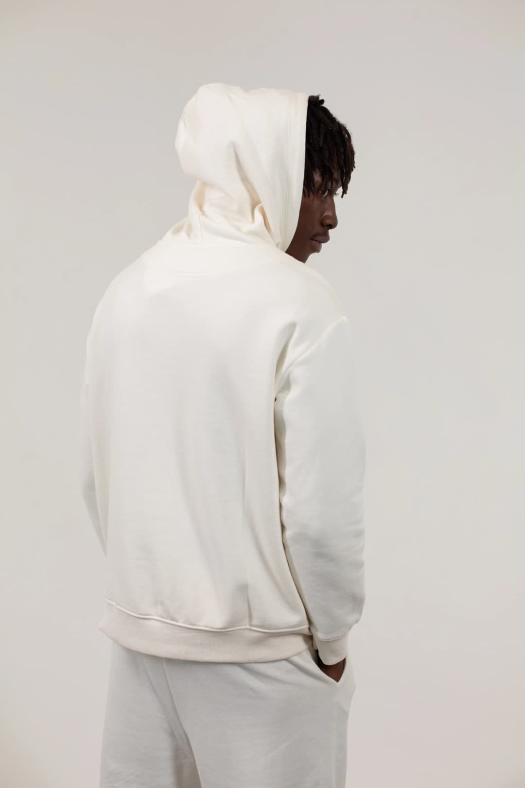 Person in plain background with a hoodie